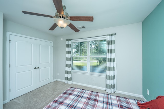 unfurnished bedroom featuring a closet, ceiling fan, and carpet flooring