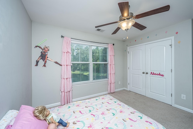 carpeted bedroom with a closet and ceiling fan