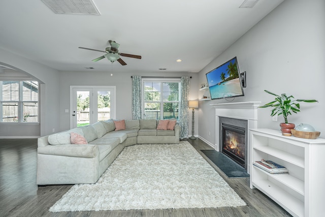 living room featuring ceiling fan and dark hardwood / wood-style flooring