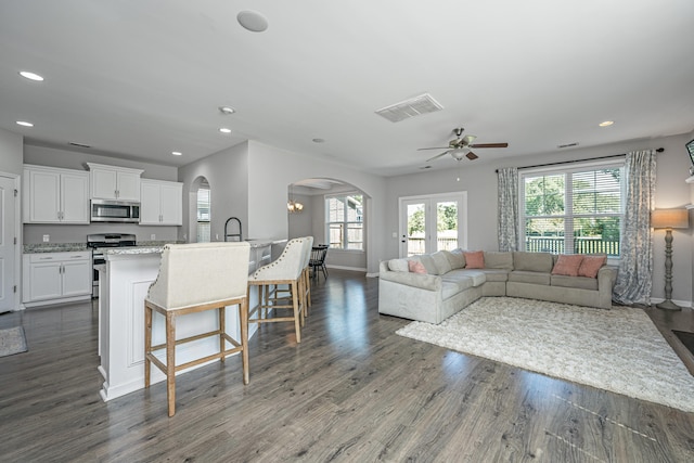 living room featuring french doors, ceiling fan, and dark hardwood / wood-style flooring