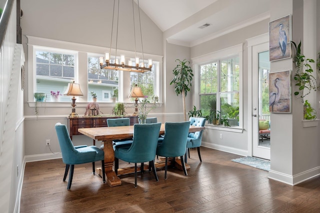 dining area with an inviting chandelier, dark hardwood / wood-style flooring, and high vaulted ceiling