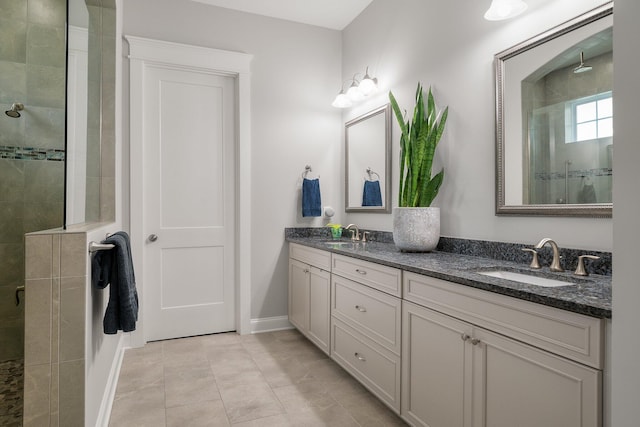 bathroom with vanity, tile patterned floors, and tiled shower