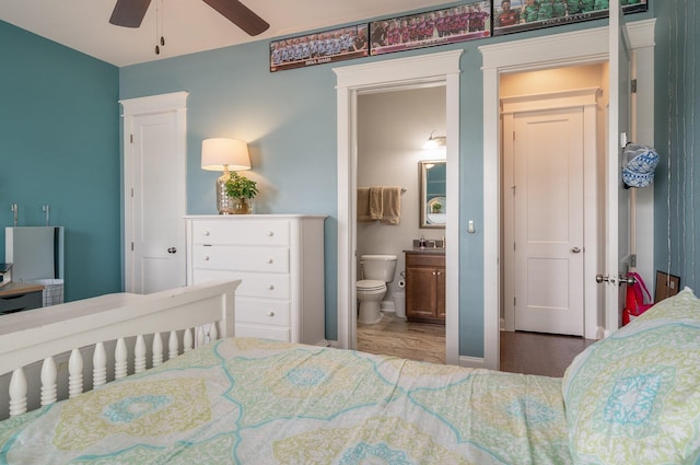 bedroom featuring ensuite bathroom and wood-type flooring