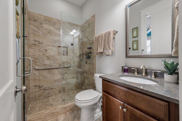 bathroom featuring vanity, toilet, and an enclosed shower