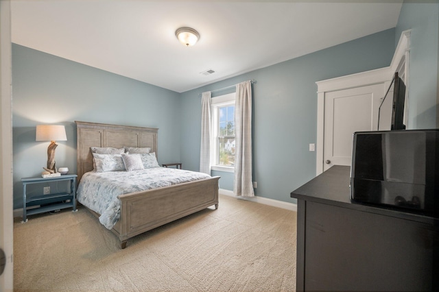 bedroom featuring light carpet