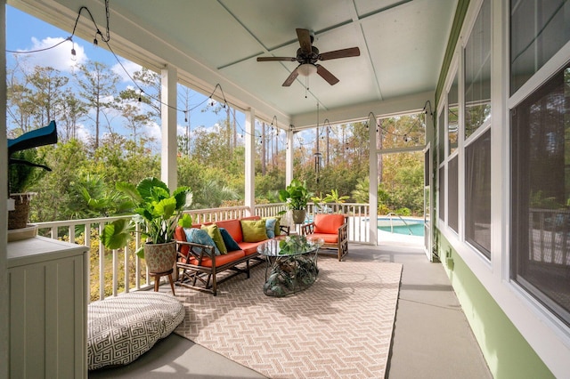 sunroom / solarium featuring ceiling fan