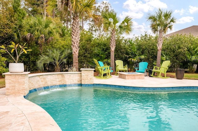 view of swimming pool with a fire pit, a patio area, and pool water feature