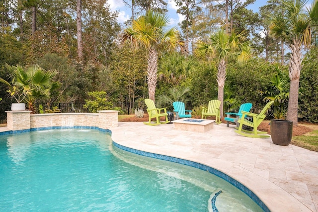 view of pool featuring pool water feature, an outdoor fire pit, and a patio