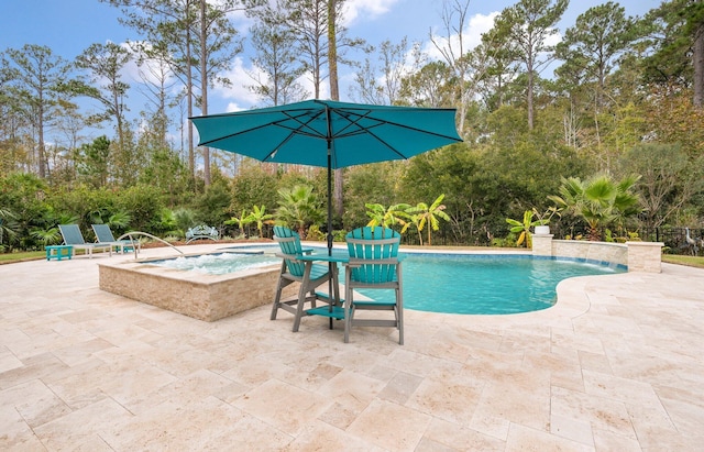 view of pool featuring a patio, pool water feature, and an in ground hot tub