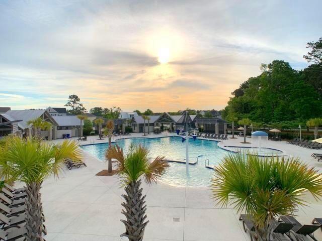 pool at dusk with a patio area