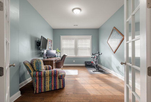 home office featuring hardwood / wood-style flooring, french doors, and a healthy amount of sunlight