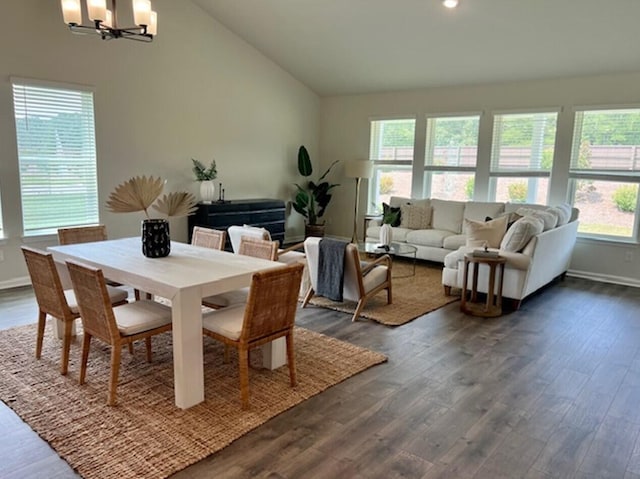 dining area with baseboards, dark wood finished floors, recessed lighting, a notable chandelier, and high vaulted ceiling