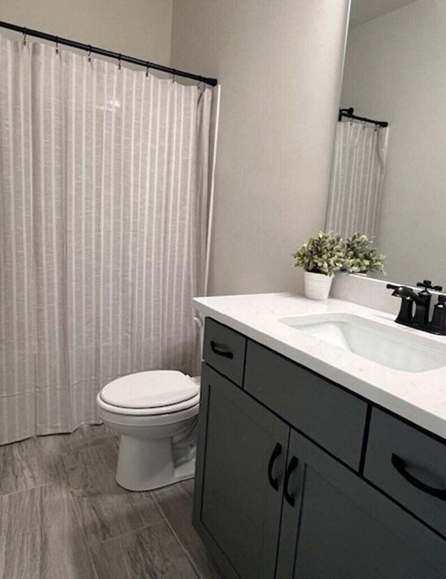 bathroom featuring toilet and vanity