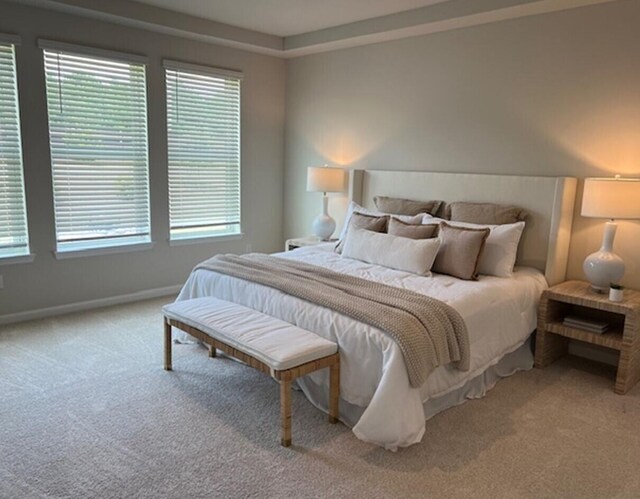 carpeted bedroom featuring baseboards