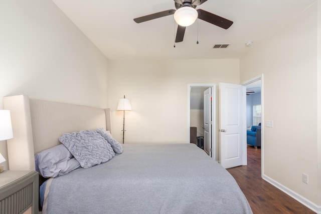 bedroom with dark wood-type flooring, baseboards, visible vents, and ceiling fan