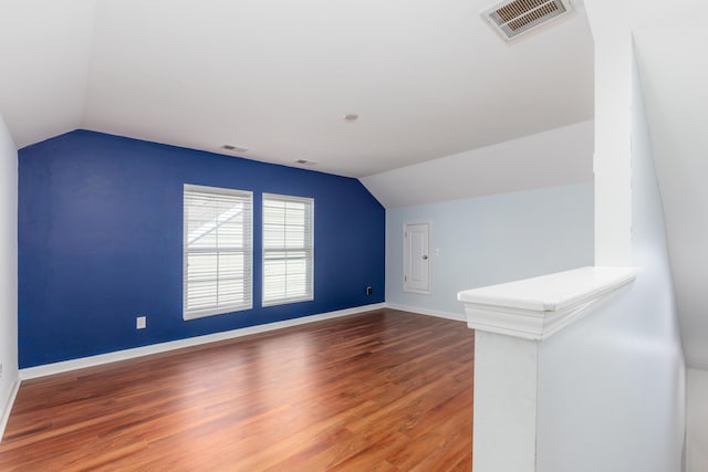 bonus room featuring visible vents, baseboards, lofted ceiling, and wood finished floors