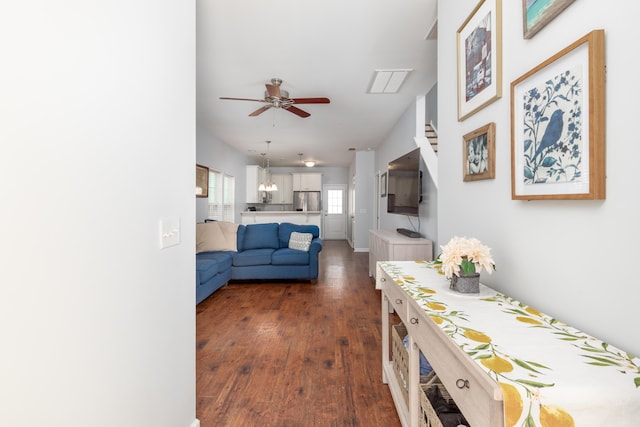 living area featuring dark wood finished floors and a ceiling fan