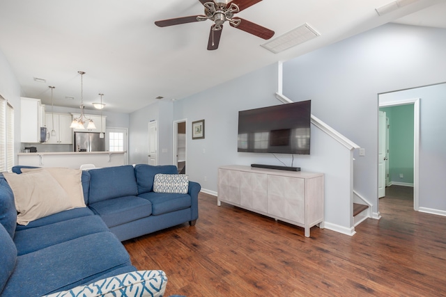 living area with stairs, wood finished floors, visible vents, and ceiling fan