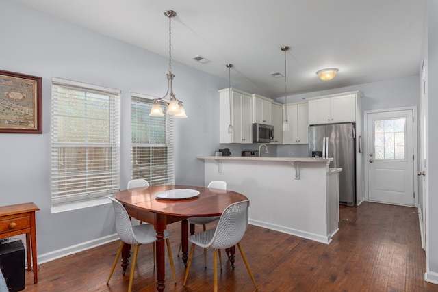 dining space featuring baseboards, visible vents, and dark wood-style flooring