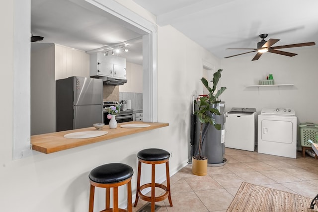 4932 N Rhett Ave, North Charleston, SC 29405 - kitchen featuring stainless steel appliances, separate washer and dryer, electric water heater, tasteful backsplash, and ceiling fan