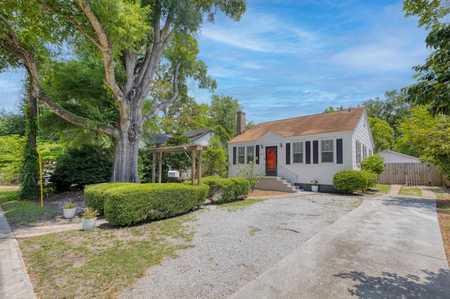 4932 N Rhett Ave, North Charleston, SC 29405 - view of front facade featuring concrete driveway, a chimney, and a pergola