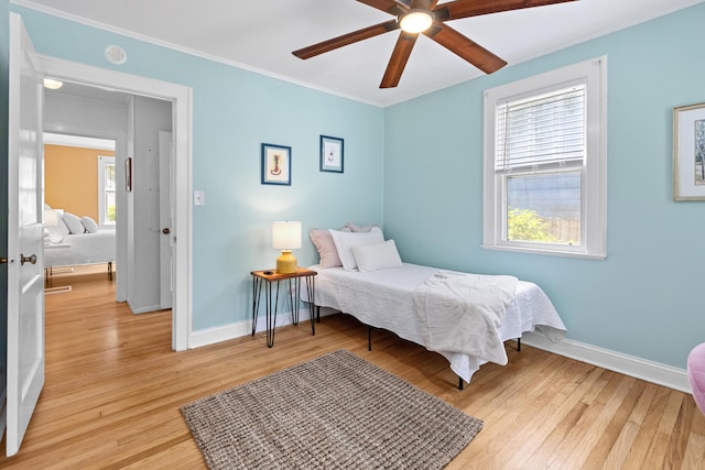 4932 N Rhett Ave, North Charleston, SC 29405 - bedroom with baseboards, light wood-style floors, crown molding, and ceiling fan
