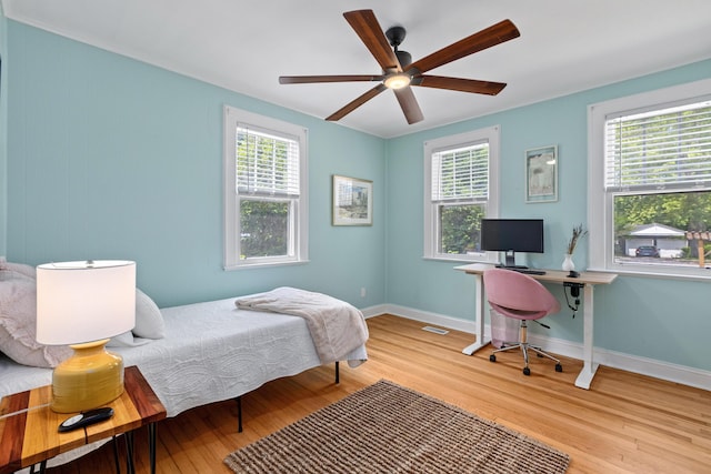4932 N Rhett Ave, North Charleston, SC 29405 - bedroom featuring wood finished floors, multiple windows, and baseboards