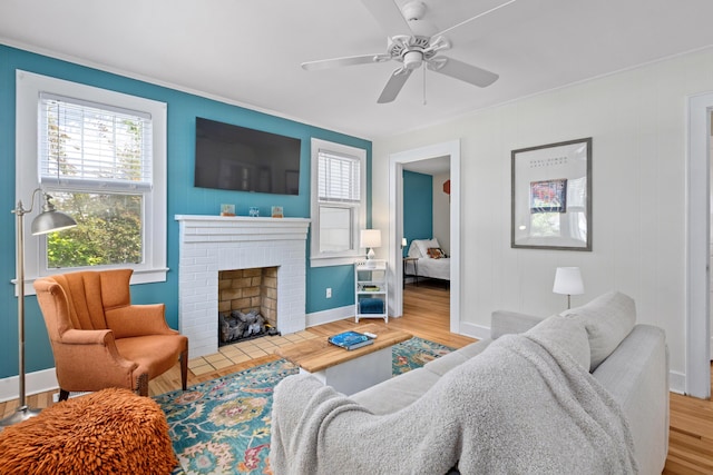 4932 N Rhett Ave, North Charleston, SC 29405 - living room featuring wood finished floors, a brick fireplace, baseboards, and crown molding