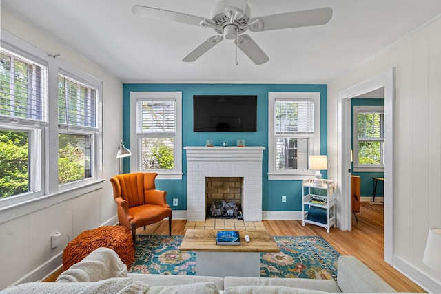 4932 N Rhett Ave, North Charleston, SC 29405 - living room with wood finished floors, ornamental molding, a brick fireplace, a ceiling fan, and baseboards