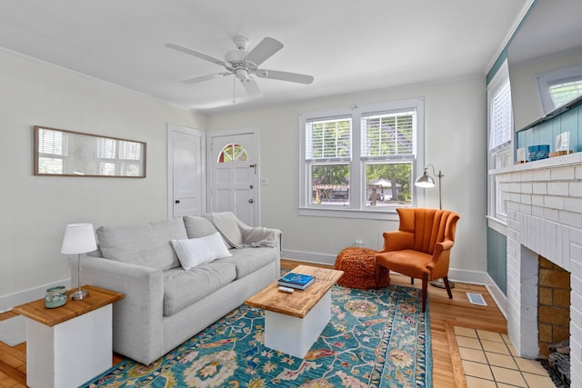 4932 N Rhett Ave, North Charleston, SC 29405 - living area with plenty of natural light, baseboards, light wood-style flooring, and a brick fireplace