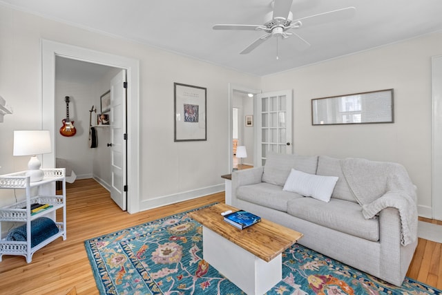 4932 N Rhett Ave, North Charleston, SC 29405 - living area with light wood-style floors, ceiling fan, and baseboards
