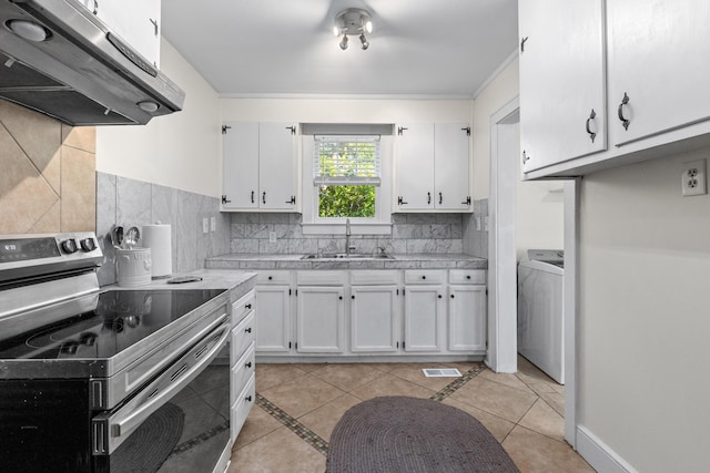 4932 N Rhett Ave, North Charleston, SC 29405 - kitchen featuring stainless steel electric range, a sink, extractor fan, washer / clothes dryer, and white cabinetry