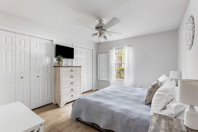 7935 Parklane Ct Unit A, North Charleston, SC 29418 - bedroom with multiple closets, light wood-style floors, a textured ceiling, and ceiling fan