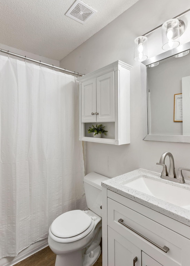 7935 Parklane Ct Unit A, North Charleston, SC 29418 - bathroom with toilet, vanity, a textured ceiling, wood finished floors, and a shower with curtain