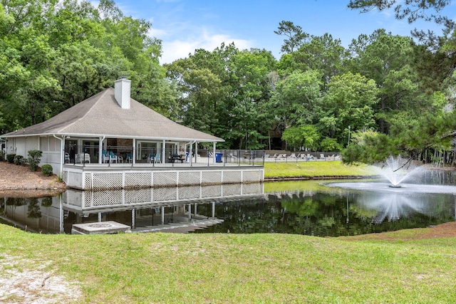 7935 Parklane Ct Unit A, North Charleston, SC 29418 - back of property with a water view, a chimney, a lawn, and roof with shingles