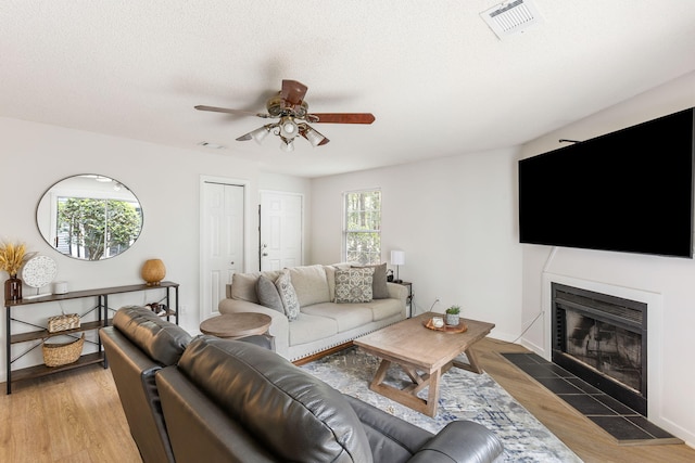 7935 Parklane Ct Unit A, North Charleston, SC 29418 - living room with a ceiling fan, a fireplace with flush hearth, and light wood-type flooring