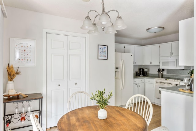 7935 Parklane Ct Unit A, North Charleston, SC 29418 - dining area featuring a chandelier and light wood-style flooring