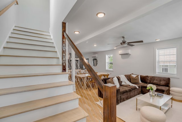 living room with light wood-style floors, recessed lighting, a wall mounted air conditioner, and stairway