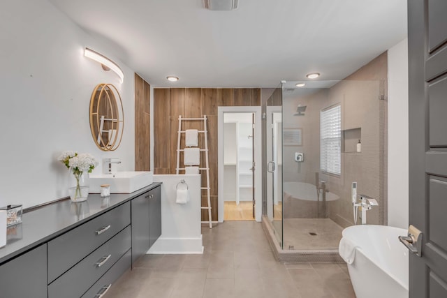 bathroom featuring recessed lighting, a soaking tub, a stall shower, vanity, and tile patterned floors