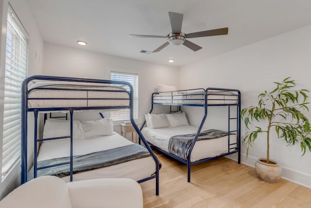 bedroom with baseboards, visible vents, wood finished floors, and recessed lighting