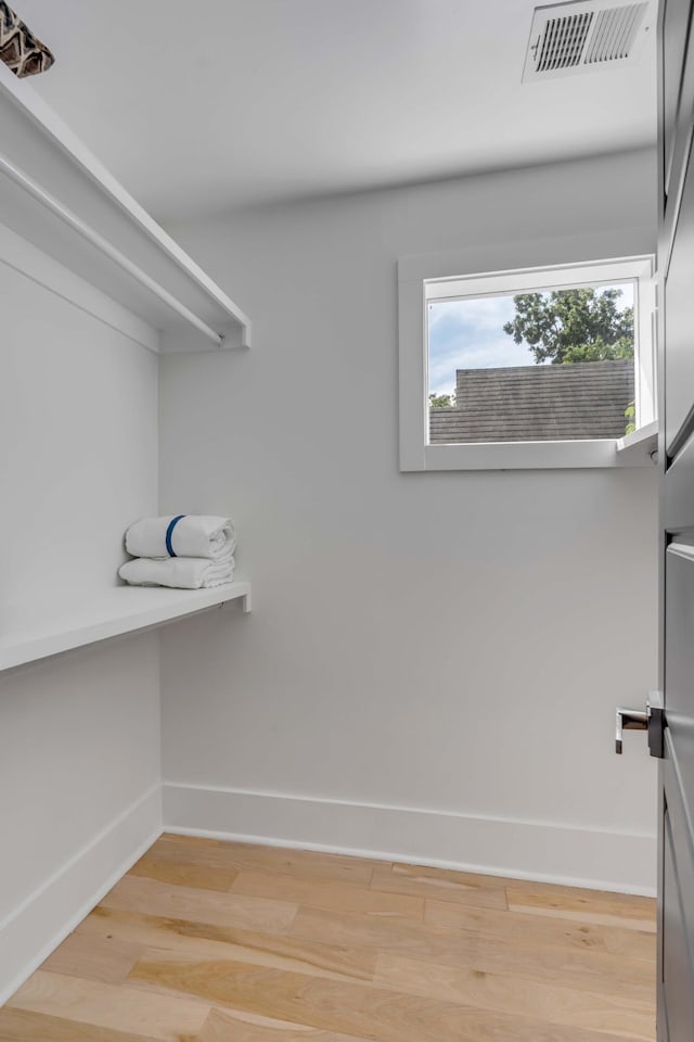 spacious closet featuring visible vents and light wood-style flooring