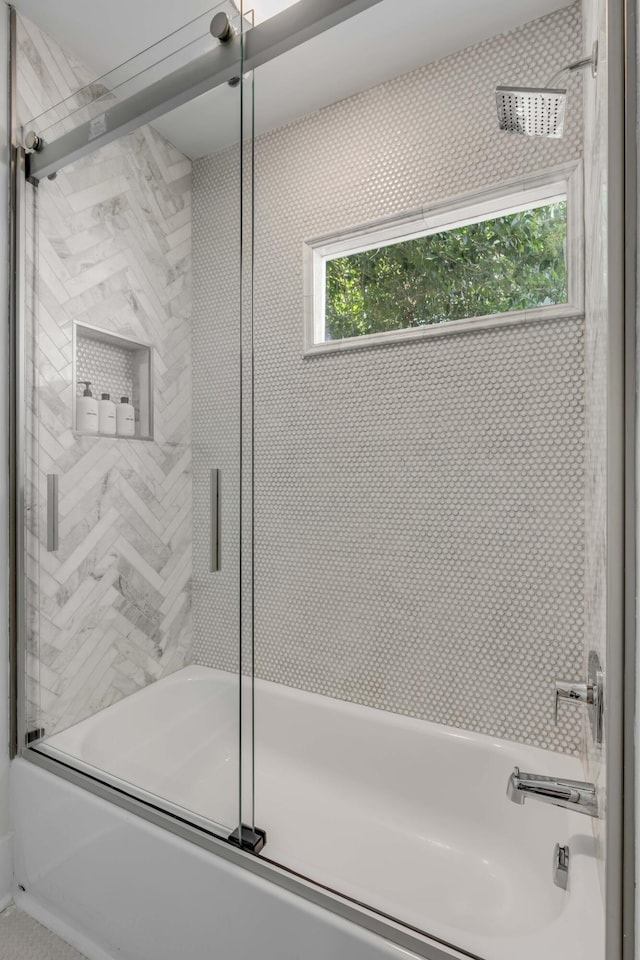 full bathroom with bath / shower combo with glass door