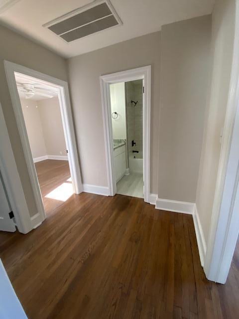 corridor featuring dark hardwood / wood-style floors