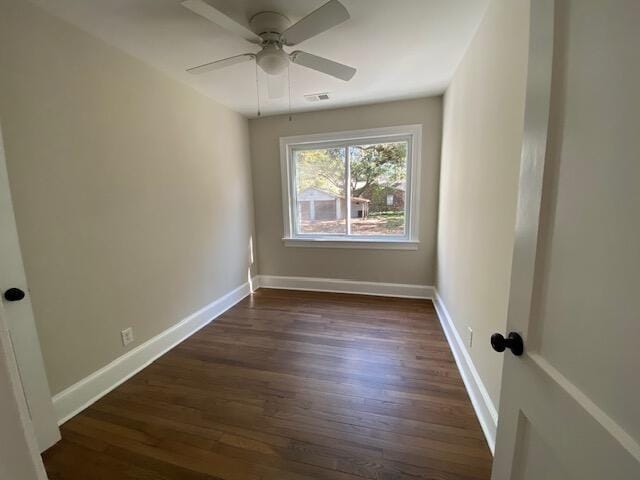 spare room featuring dark hardwood / wood-style flooring and ceiling fan