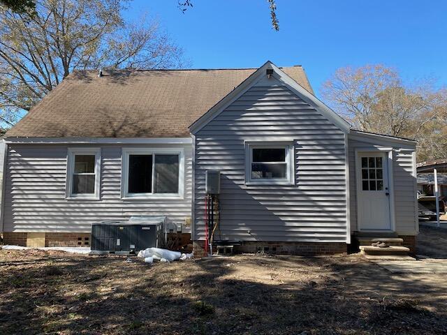 back of property featuring central AC