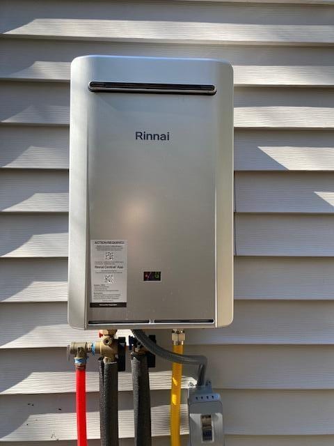 exterior details featuring tankless water heater