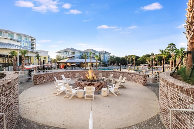 view of patio featuring a community pool and a fire pit