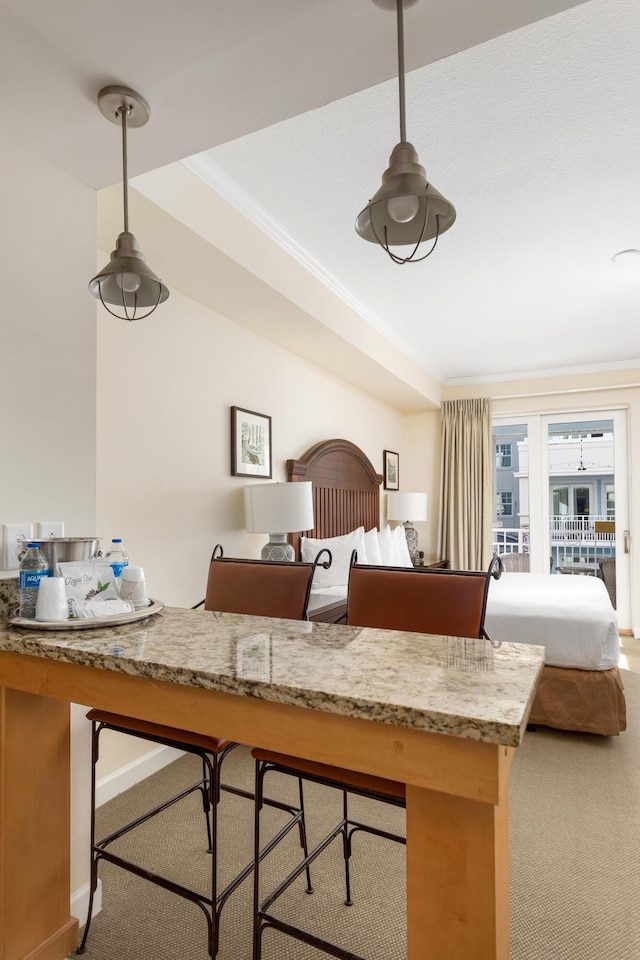 carpeted bedroom with ornamental molding and baseboards