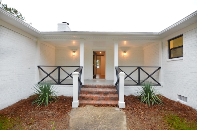 entrance to property featuring covered porch