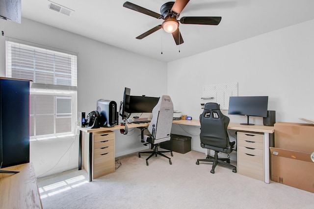 office area with visible vents, ceiling fan, and carpet flooring